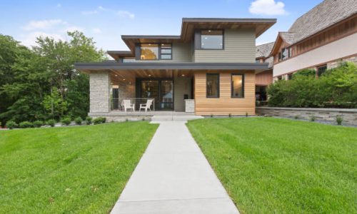 Long concrete sidewalk leading to the front door and porch area Long concrete sidewalk leading to the front door and porch area